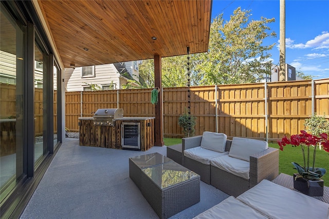 view of patio with an outdoor hangout area, an outdoor kitchen, wine cooler, and area for grilling