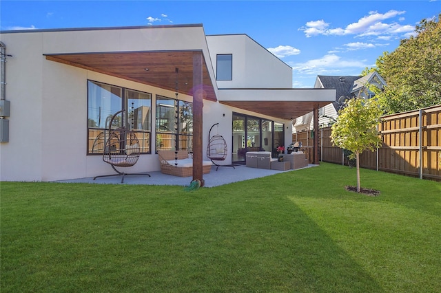 back of property featuring an outdoor hangout area, a yard, and a patio