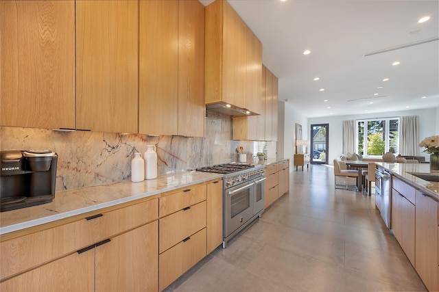 kitchen with appliances with stainless steel finishes, light brown cabinetry, backsplash, and light stone counters