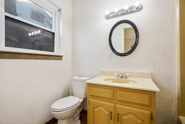 bathroom featuring toilet and vanity