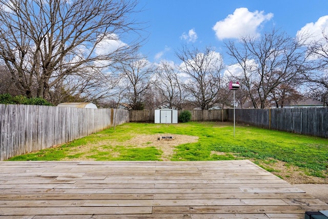 view of yard with a deck and a storage unit