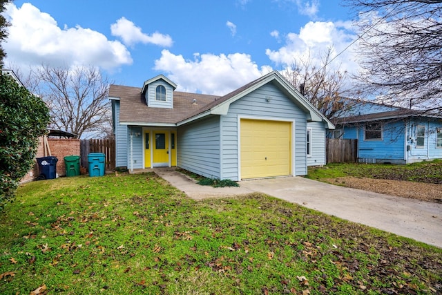 view of front of property with a front yard and a garage