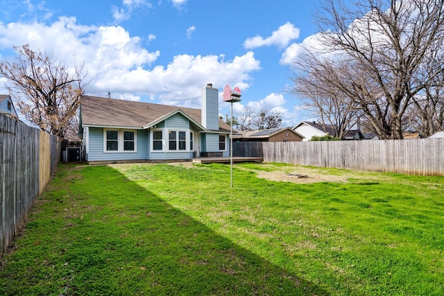 rear view of house with a lawn