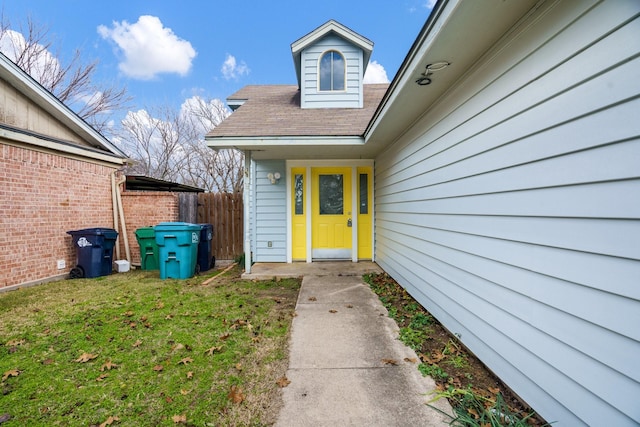 entrance to property with a lawn