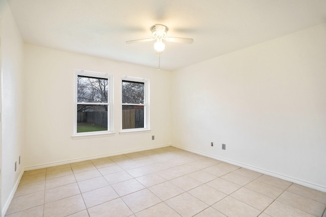 spare room featuring ceiling fan and light tile patterned flooring