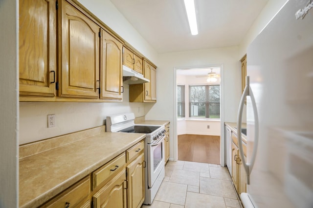 kitchen with ceiling fan, white appliances, and light tile patterned floors