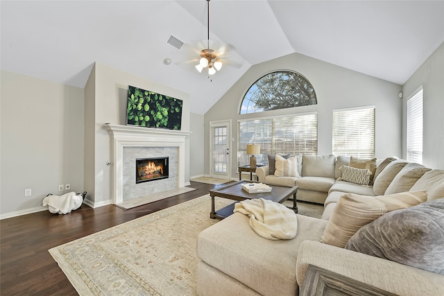 living room with ceiling fan, high vaulted ceiling, dark wood-type flooring, and a fireplace