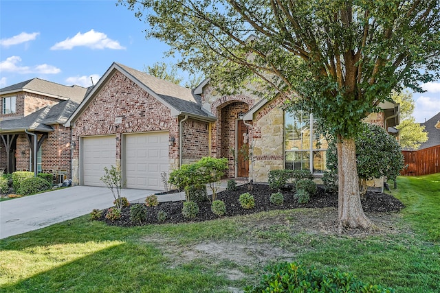 view of front of home featuring a front yard, driveway, a garage, stone siding, and brick siding