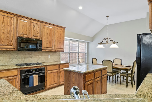 kitchen with light tile patterned flooring, vaulted ceiling, light stone counters, and black appliances