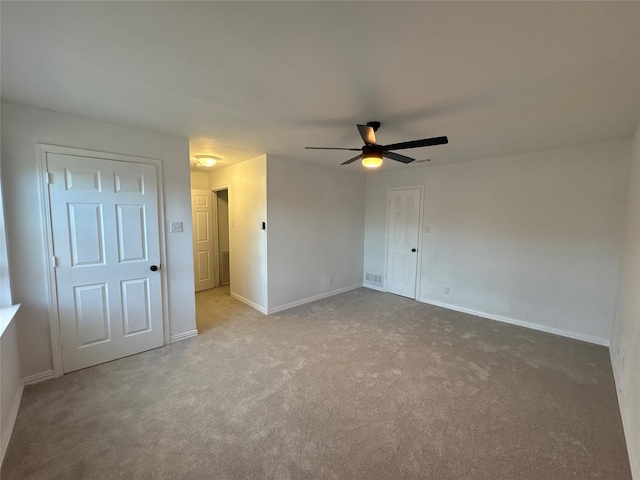 unfurnished bedroom featuring baseboards, carpet floors, and ceiling fan