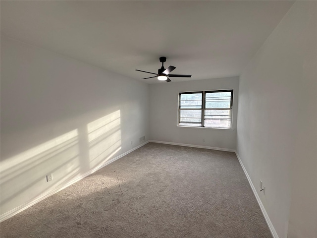 unfurnished room featuring ceiling fan and carpet floors