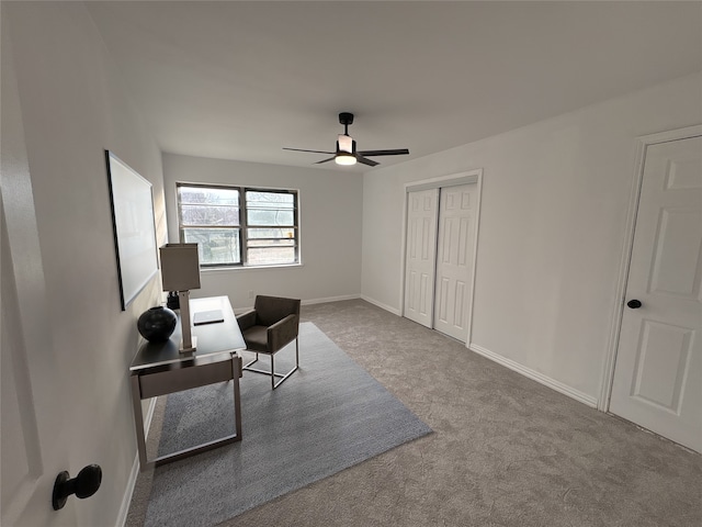 living area with carpet flooring, baseboards, and ceiling fan