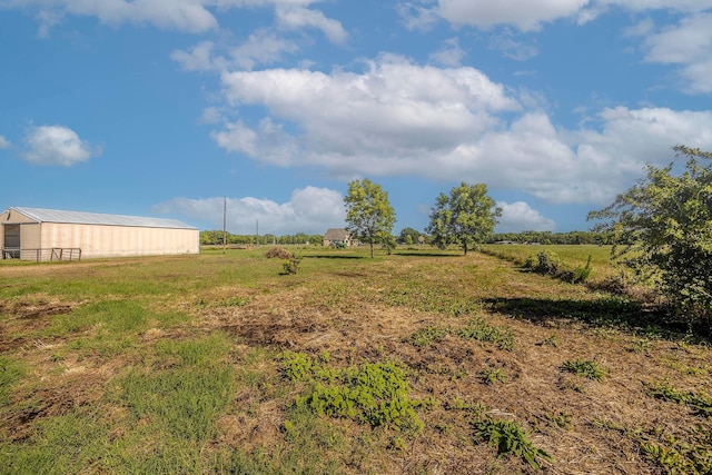 view of yard featuring an outbuilding and a rural view