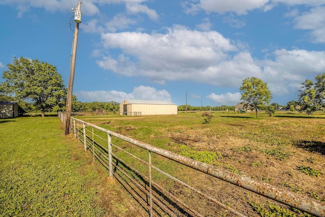 view of yard featuring an outbuilding and a rural view