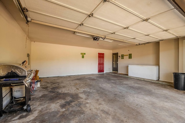 garage with a garage door opener and refrigerator