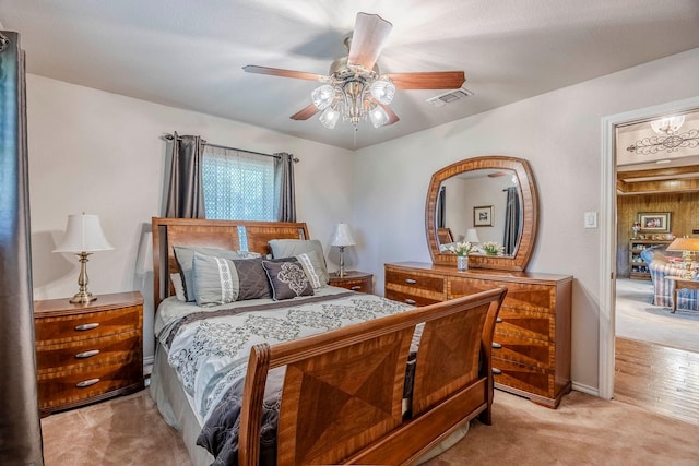 bedroom featuring ceiling fan and light carpet