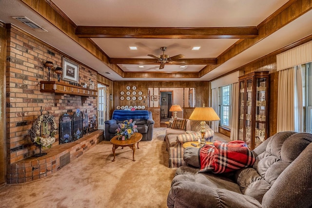 carpeted living room with ceiling fan and wood walls