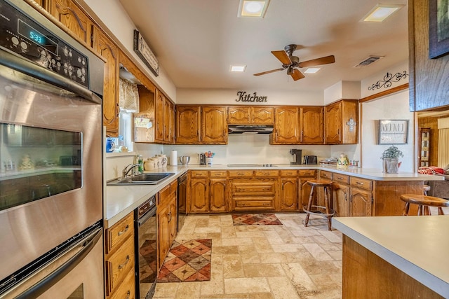 kitchen with ceiling fan, sink, black electric cooktop, and stainless steel double oven