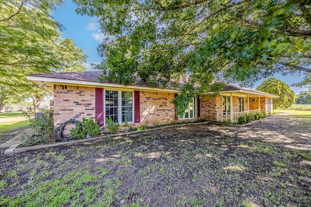 ranch-style house with covered porch