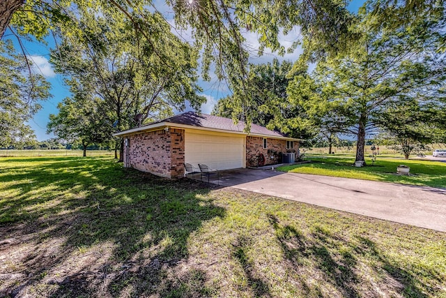 view of home's exterior featuring a lawn and central AC unit