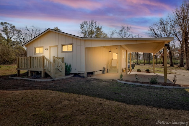 back house at dusk with a carport