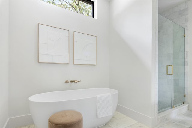 bathroom featuring shower with separate bathtub