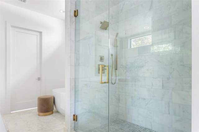 bathroom featuring shower with separate bathtub