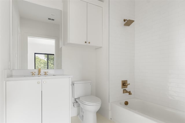 full bathroom with toilet, tiled shower / bath, and vanity