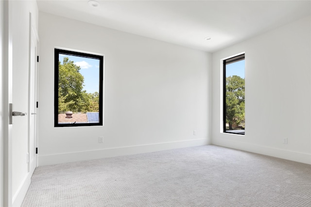 unfurnished room with light colored carpet