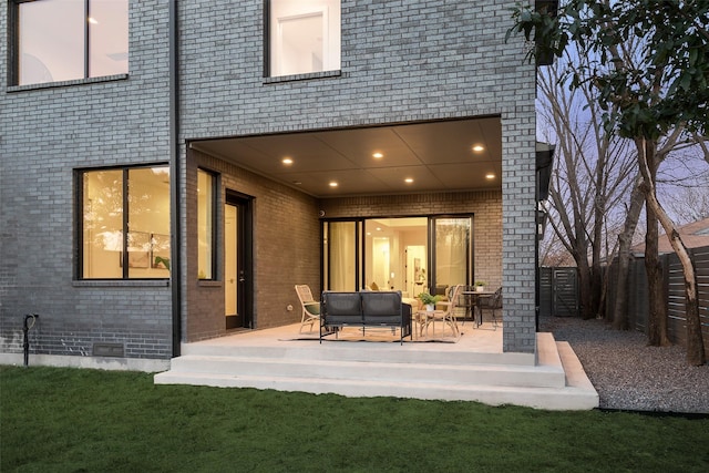 back of property with a patio area and outdoor lounge area