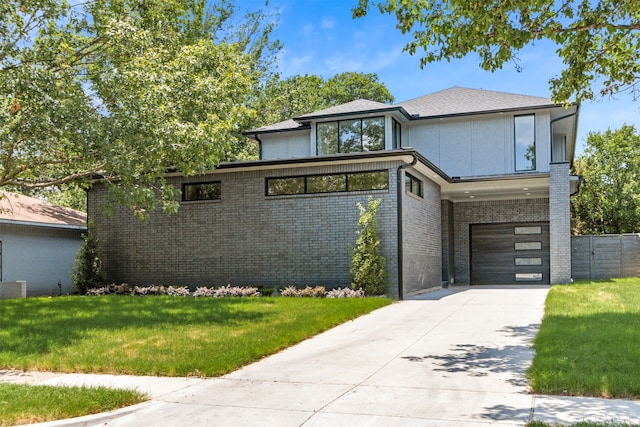 prairie-style house featuring a garage and a front yard