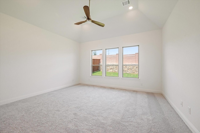 empty room featuring ceiling fan, light carpet, and lofted ceiling