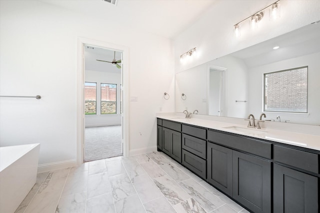 bathroom with ceiling fan, vanity, and a bathing tub