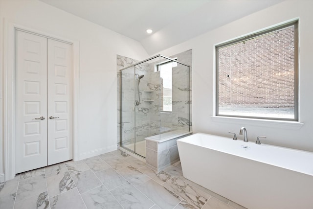 bathroom with lofted ceiling and independent shower and bath