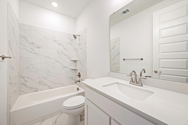 full bathroom with toilet, vanity, and tiled shower / bath