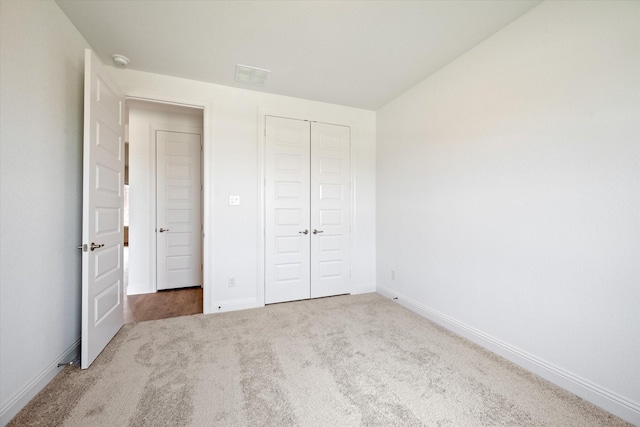 unfurnished bedroom with carpet floors and a closet