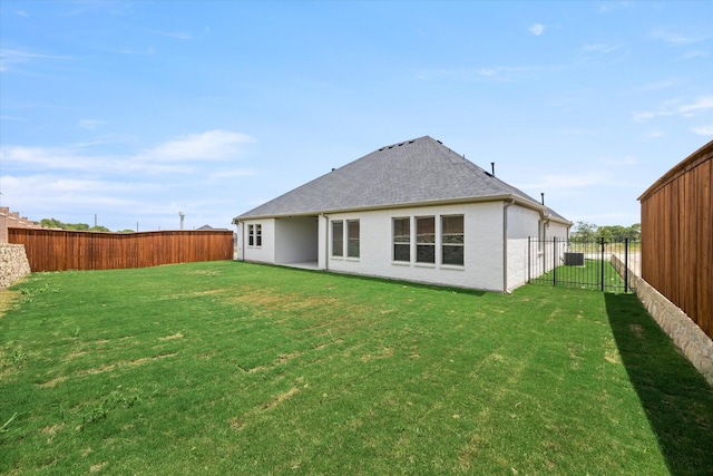 rear view of house featuring a lawn