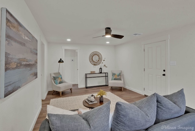 living room with ceiling fan and hardwood / wood-style flooring