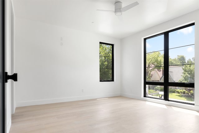 unfurnished room with light wood-type flooring and ceiling fan