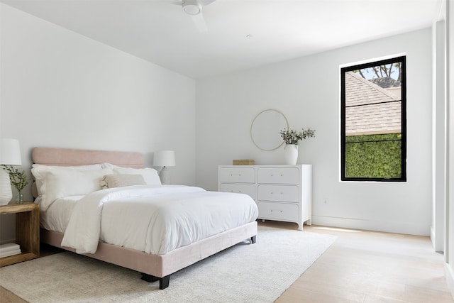 bedroom with ceiling fan and light hardwood / wood-style flooring