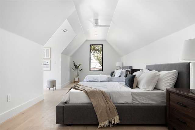 bedroom with ceiling fan, light hardwood / wood-style floors, and lofted ceiling