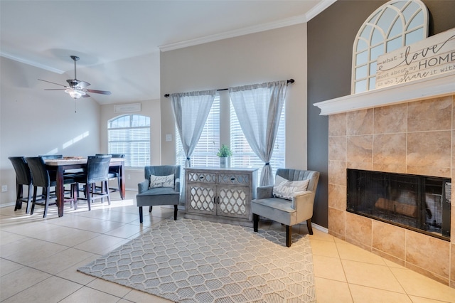 living room with ceiling fan, light tile patterned floors, a fireplace, and ornamental molding