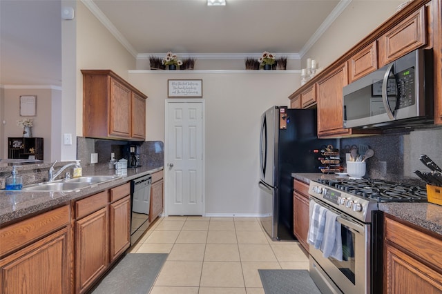 kitchen with backsplash, appliances with stainless steel finishes, sink, and ornamental molding