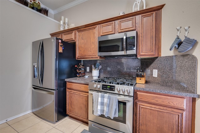 kitchen featuring light tile patterned flooring, appliances with stainless steel finishes, ornamental molding, and backsplash