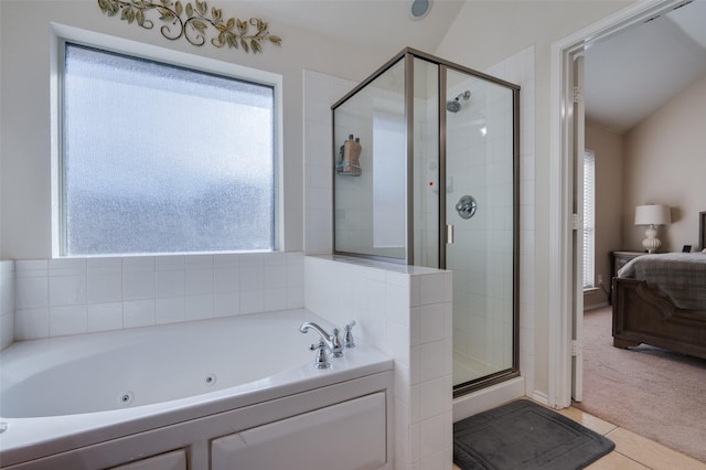 bathroom featuring lofted ceiling, tile patterned floors, and a wealth of natural light