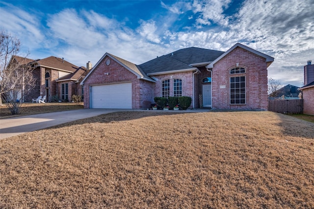 view of front of home with a garage and a front lawn