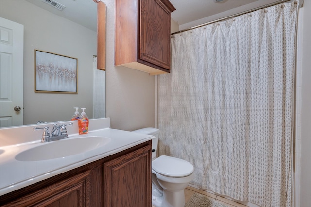 bathroom featuring curtained shower, tile patterned floors, toilet, and vanity