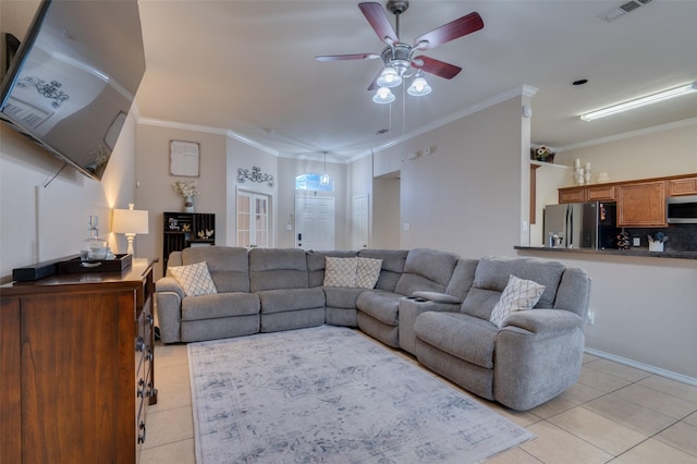 living room with ceiling fan, light tile patterned floors, and crown molding