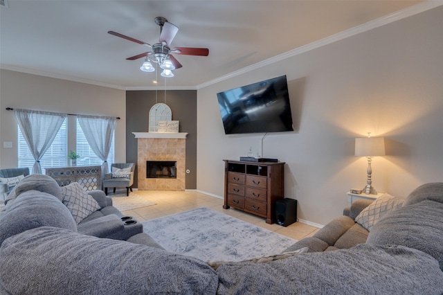 living room with ceiling fan, light tile patterned floors, ornamental molding, and a fireplace