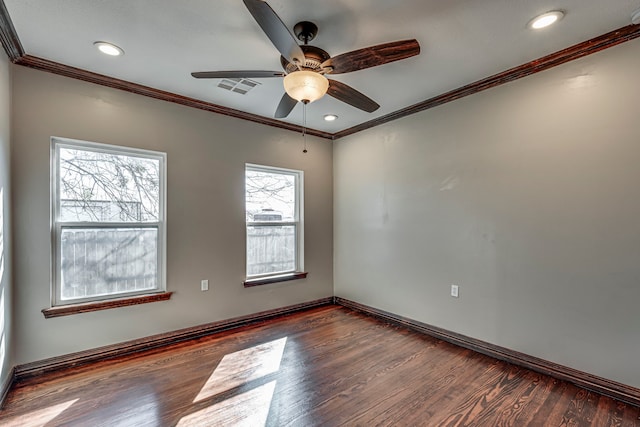 empty room featuring ceiling fan, dark wood-type flooring, and crown molding